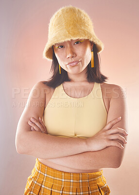 Buy stock photo Asian woman, fashion and confident, gen z and portrait, yellow aesthetic and edgy on studio background. Streetwear style, beauty and cosmetics, female and empowerment, attitude with arms crossed