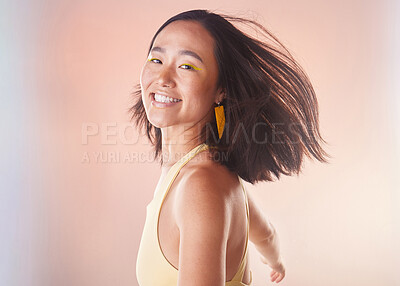 Buy stock photo Portrait, fashion and beauty with a model asian woman in studio on a neon background for style. Face, carefree and freedom with an attractive young female standing alone for natural cosmetics