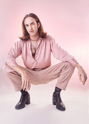 Buy stock photo Fashion, style and lgbt, portrait of man with pride, confidence and pose isolated on pink background. Makeup, aesthetic and model with beauty in studio, creative non binary and gender neutral design.