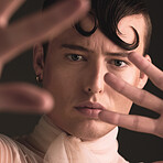 Beauty portrait of transgender man isolated on dark background for creative and queer fashion aesthetic. Young lgbtq model or gay person face with cosmetics, makeup and hands for art style in studio