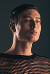 Gender neutral person, fashion and lgbtq gen z youth, face and beauty, edgy style on dark background in studio. Non binary, lgbt community and queer model, trendy and designer clothes with cosmetics