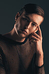 Gender neutral person, fashion and portrait on dark background, trendy and edgy. Creative, gen z and thinking with beauty, sexy with cosmetics and serious, non binary and designer clothes in studio