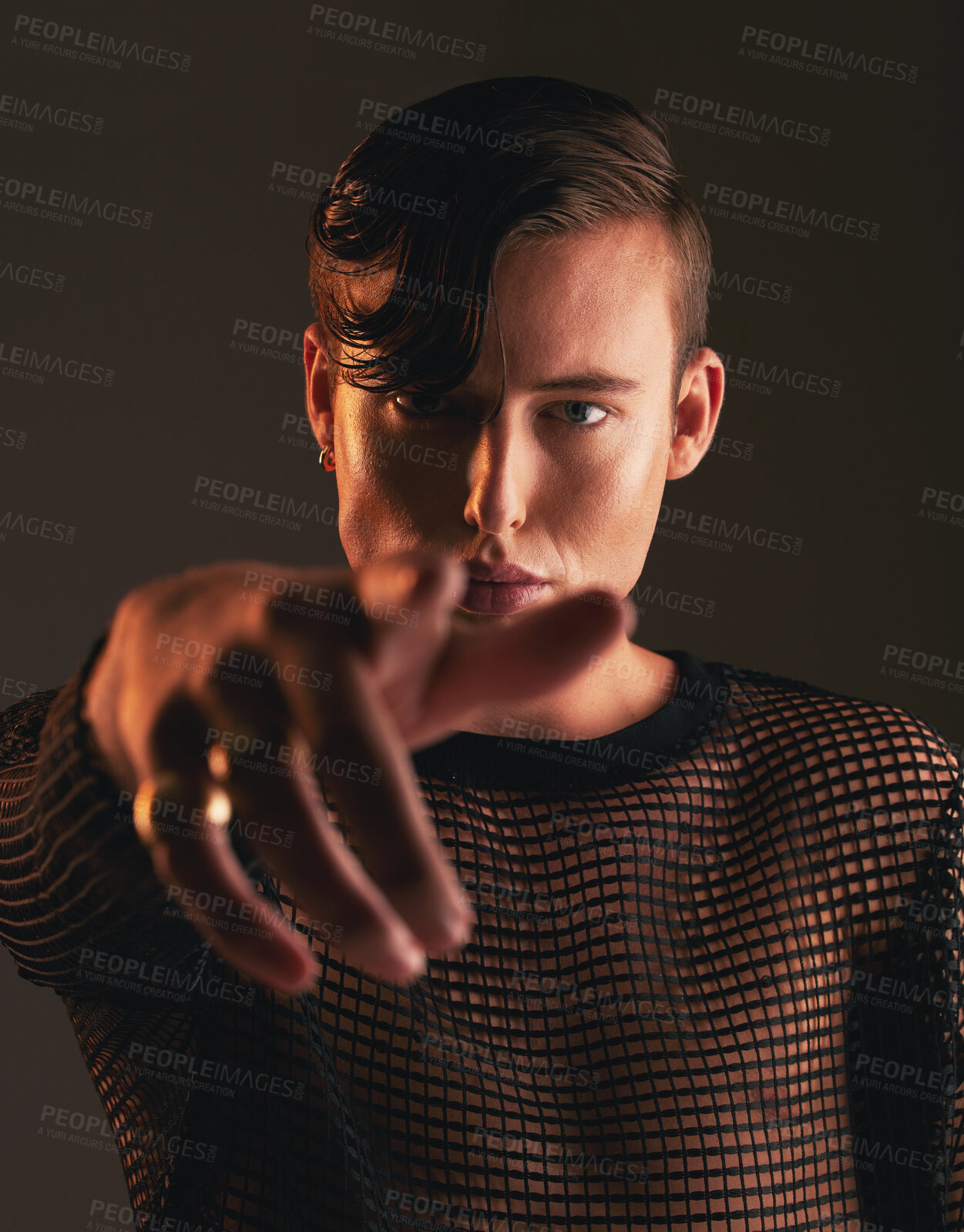 Buy stock photo Gender neutral person, fashion and hand on dark background, trendy and edgy art. Creative, gen z and beauty, pointing and sexy with cosmetics, young and non binary with designer clothes in portrait