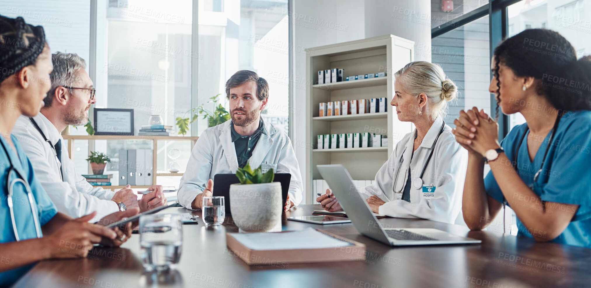 Buy stock photo Meeting, team and doctors in discussion in the hospital conference room for collaboration. Teamwork, medical and group of healthcare workers talking about a diagnosis, strategy or treatment plan.