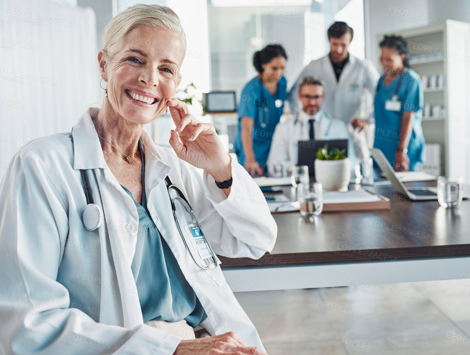 Buy stock photo Healthcare, smile and leadership, portrait of woman doctor at desk in hospital for support, teaching and medical students. Health, medicine and confident, mature and happy mentor with stethoscope.