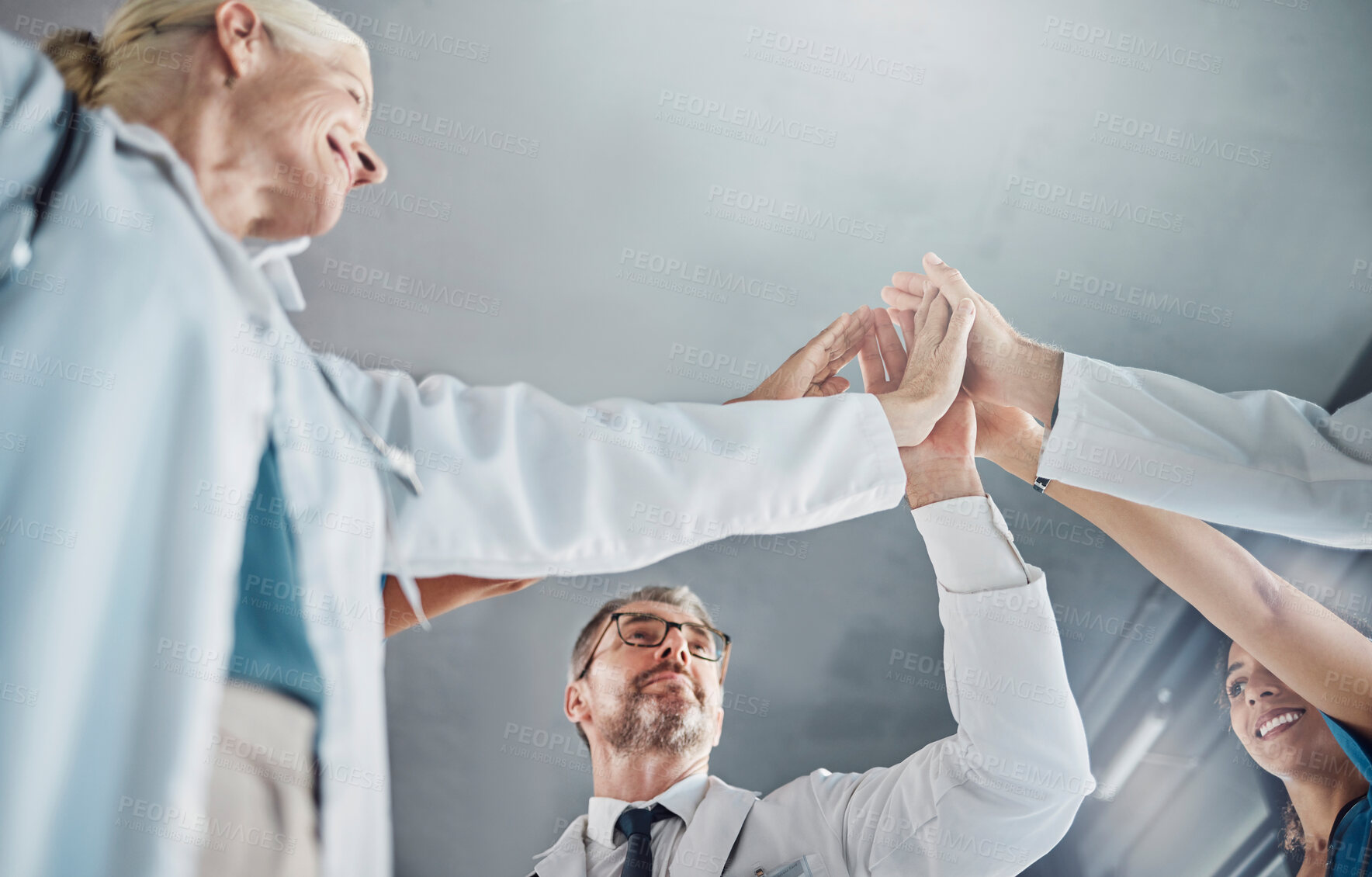 Buy stock photo Doctor, team and high five in celebration for healthcare success, good job or winning in collaboration at clinic. Hands of medical experts in teamwork celebrating achievement, agreement or goals