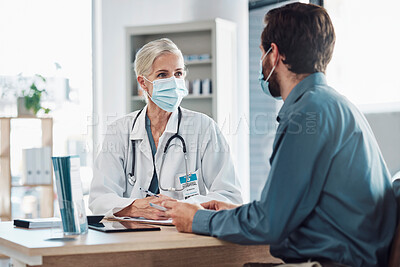 Consultation, covid and doctor with a man for healthcare, medical attention and service. Medicine, support and consultant with a face mask for virus while talking to a patient about health results