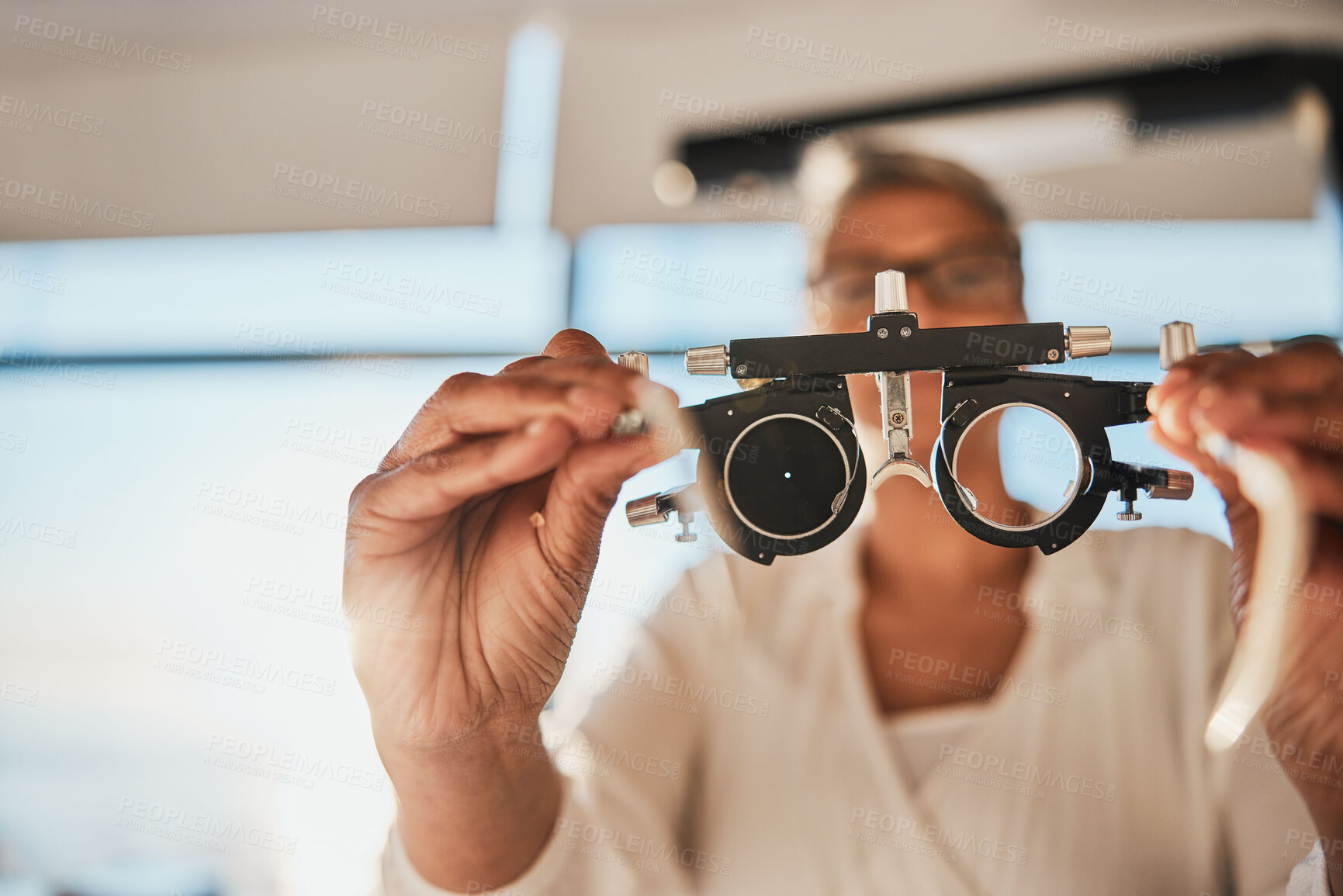 Buy stock photo Vision, hands and test frame for optometry in hospital or clinic for ophthalmology. Doctor, healthcare and female, woman or medical optician with glasses or lens for eyes examination or eye care.