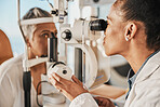 Optometry, ophthalmology and eye exam by optometrist with a patient senior woman with medical insurance using slit lamp. Doctor, eyesight and healthcare professional doing vision test in clinic