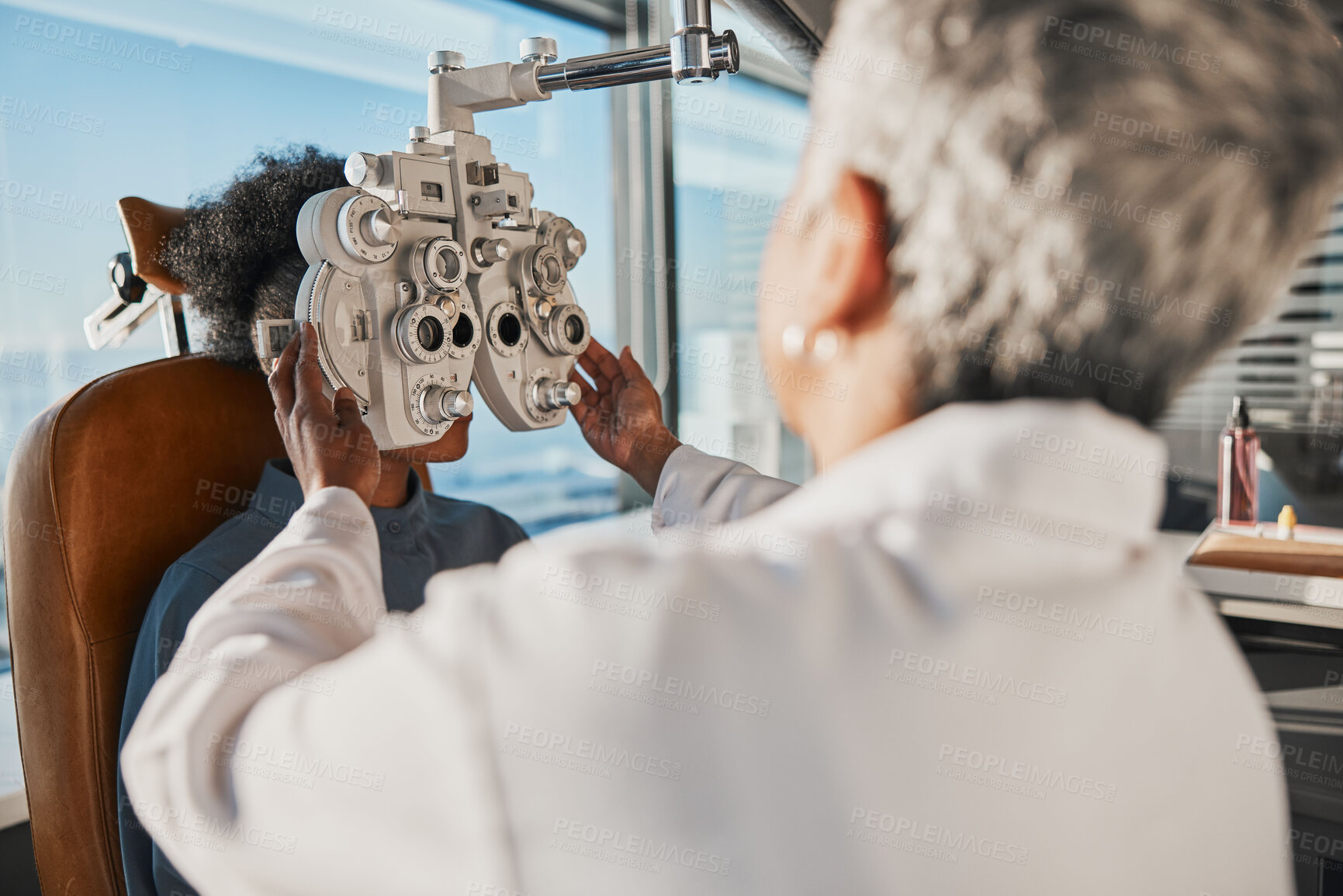 Buy stock photo Optometry, eyecare and optician doing a eye test for a patient for vision or healthcare in a clinic. Ophthalmology, medical and female optometrist doing exam for prescription lenses in optical store.