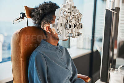 Buy stock photo Healthcare test, eye exam and black woman in optometry clinic for testing, eyesight and optical assessment. Vision, optometrist consultation and patient with medical tool, phoropter and lens for eyes