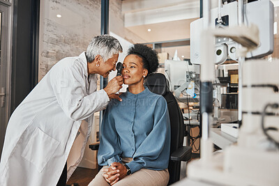 Buy stock photo Doctor, vision or black woman in eye exam consultation or assessment for eyesight at optometrist office. Mature or senior optician helping a customer testing or checking iris or retina visual health