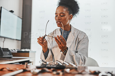 Buy stock photo Optometry, repair and optometrist fixing glasses for prescription frame in the optic clinic. Healthcare, vision and African female optician doing maintenance on eyewear or spectacles in optical store