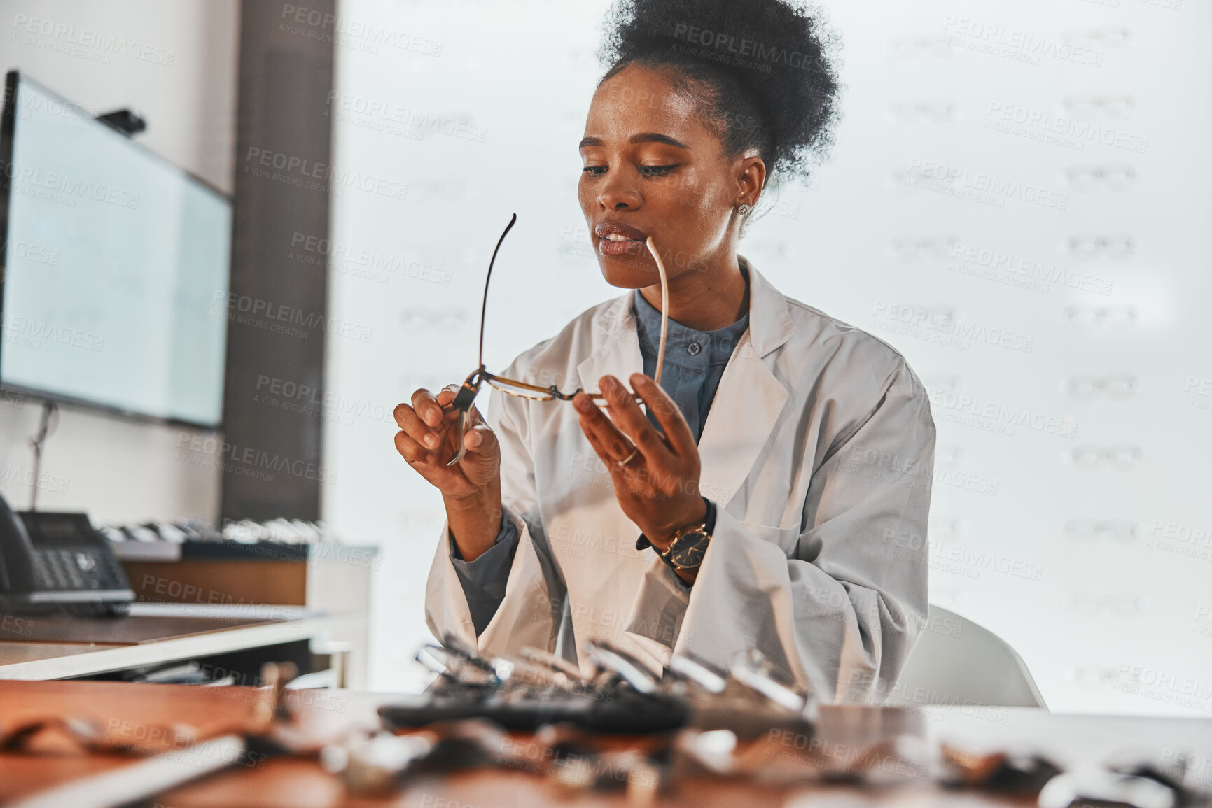 Buy stock photo Optometry, repair and optometrist fixing glasses for prescription frame in the optic clinic. Healthcare, vision and African female optician doing maintenance on eyewear or spectacles in optical store