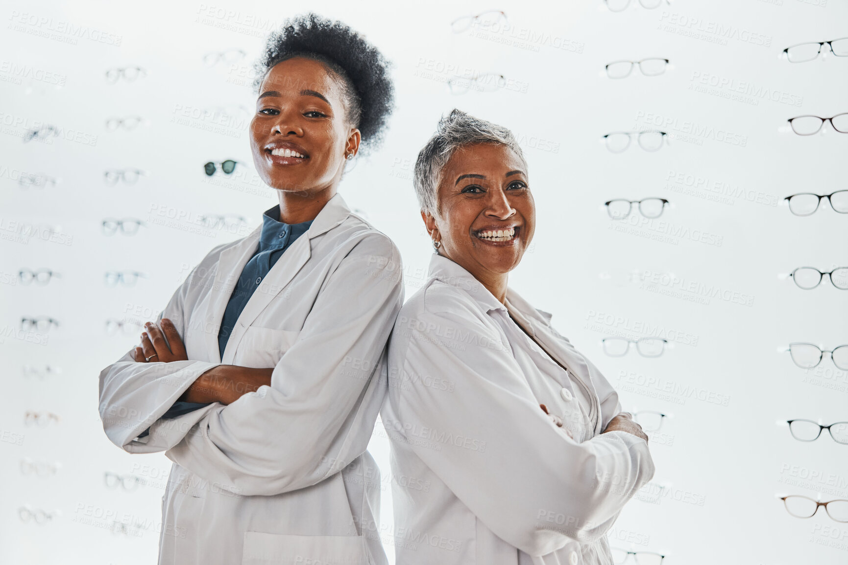 Buy stock photo Optometry, healthcare and portrait of optometrists in a clinic after optic consultation or eye test. Leadership, ophthalmology and team of women opticians standing with crossed arms in optical store.