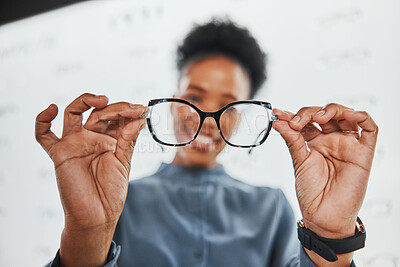 Buy stock photo Glasses, black woman hands and customer with store worker at optician clinic looking at lens. Consulting, smile and eyewear shopping in a frame shop for vision test and prescription exam for eyes