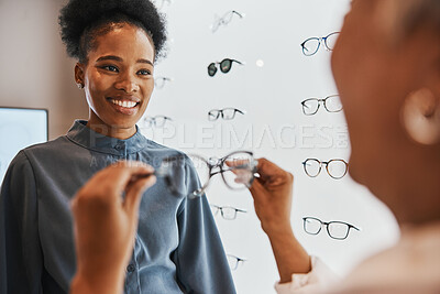 Buy stock photo Glasses, black woman and retail customer with store worker and optician looking at lens. Eye consulting, smile and eyewear assessment in a frame shop for vision test and prescription exam for eyes