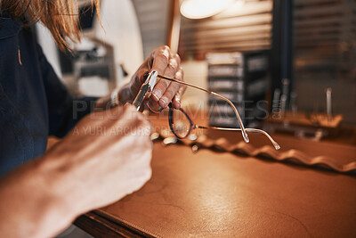 Buy stock photo Hands, glasses and optometry with an optician working in an office, cleaning eyewear for vision. Healthcare, eyeglasses and insurance with an optometrist at work in a clinic for prescription lenses