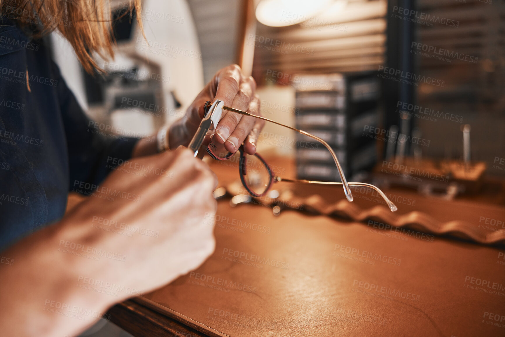 Buy stock photo Hands, glasses and optometry with an optician working in an office, cleaning eyewear for vision. Healthcare, eyeglasses and insurance with an optometrist at work in a clinic for prescription lenses