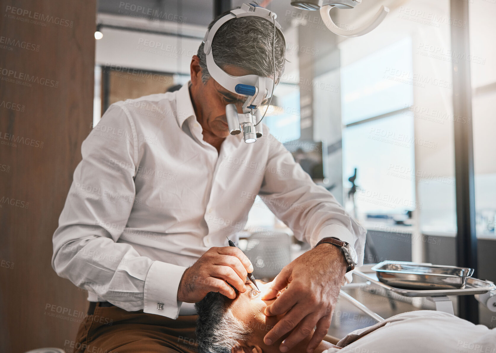 Buy stock photo Healthcare, optometry and optometrist doing a cataract surgery on a senior patient in the clinic. Medical, eye care and male optician doing ophthalmology procedure for elderly woman at optical office