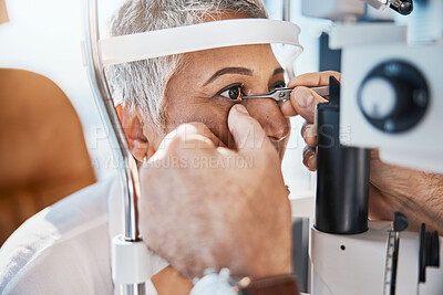 Buy stock photo Help, hands or senior woman in eye exam with doctor eyesight at optometrist or ophthalmologist. Optician helping a mature customer testing or checking vision, iris or retina visual health in office