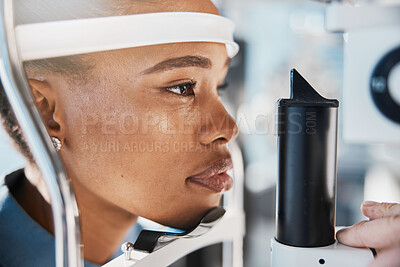 Buy stock photo Ophthalmology, eyecare and woman doing eye test at a clinic for optic wellness, health and vision. Medical, optometry and African female patient doing optical exam for prescription lenses in a store.