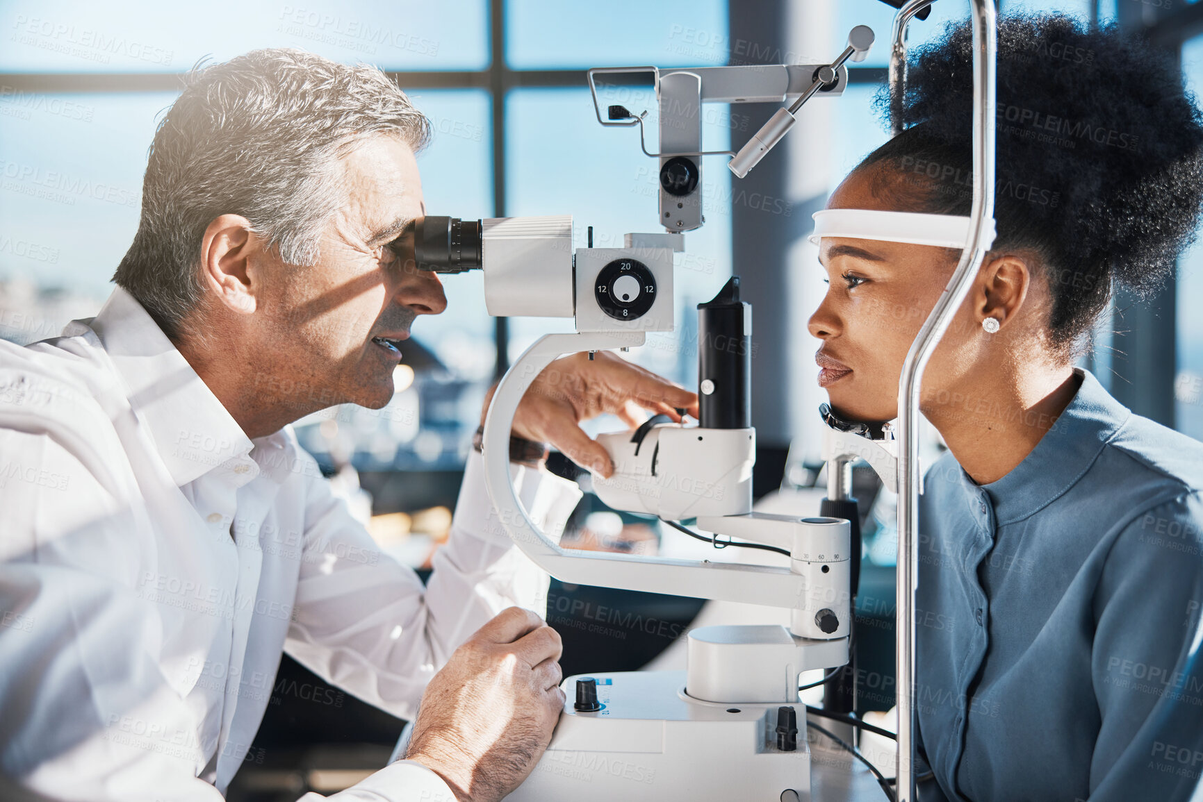 Buy stock photo Test, eye exam or black woman consulting doctor for eyesight at optometrist or ophthalmologist. African customer testing vision with mature optician helping or checking iris or retina visual health 