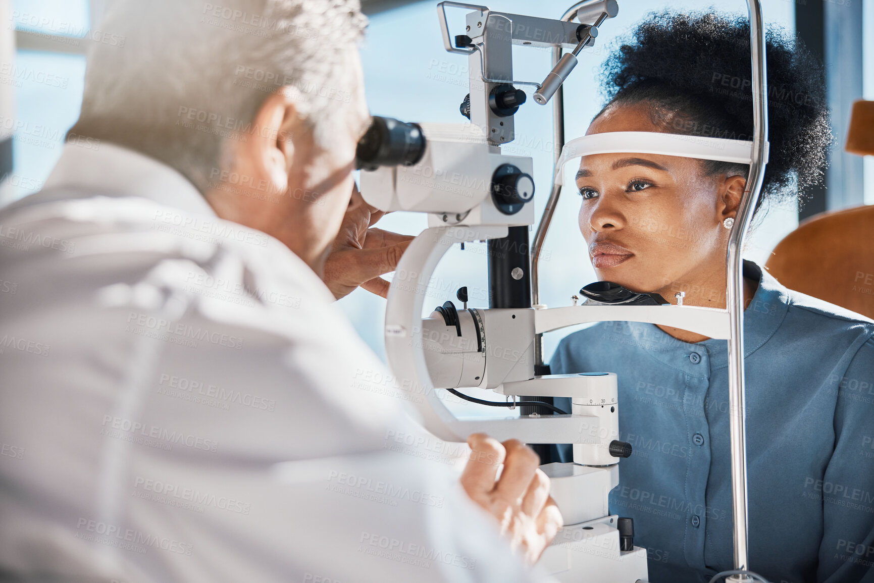 Buy stock photo Help, eye exam or black woman consulting doctor for eyesight at optometrist or ophthalmologist. African customer testing vision with mature optician checking iris, glaucoma or retina visual health