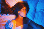 Sleeping profile, vaporwave lights and woman with cosmetics with creative neon lighting. Makeup, beauty and model resting and feeling relax and calm on a bed pillow with cyberpunk aesthetic 