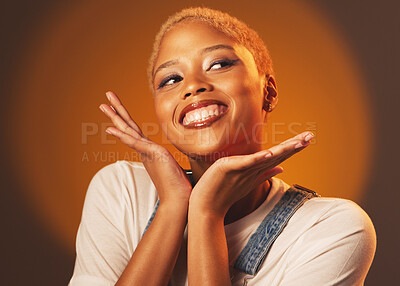 Playful, happy and beautiful black woman with hands isolated on a brown  studio background. Crazy, funny and African girl with perfect makeup,  cosmetics and excited to show face on a backdrop |