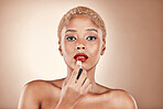 Black woman, makeup and portrait with red lipstick on a brown background for beauty cosmetics. Aesthetic model or strong person in studio for skincare, self care and facial glow on skin and bold lips