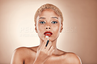 Buy stock photo Black woman, makeup and portrait with red lipstick on a brown background for beauty cosmetics. Aesthetic model or focus person in studio for skincare, self care and facial glow on skin and bold lips