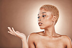 Beauty, skincare and profile of black woman with hand out on mockup in studio for bronze luxury cosmetics. Natural makeup, spa facial and model on brown background, product placement and glowing skin