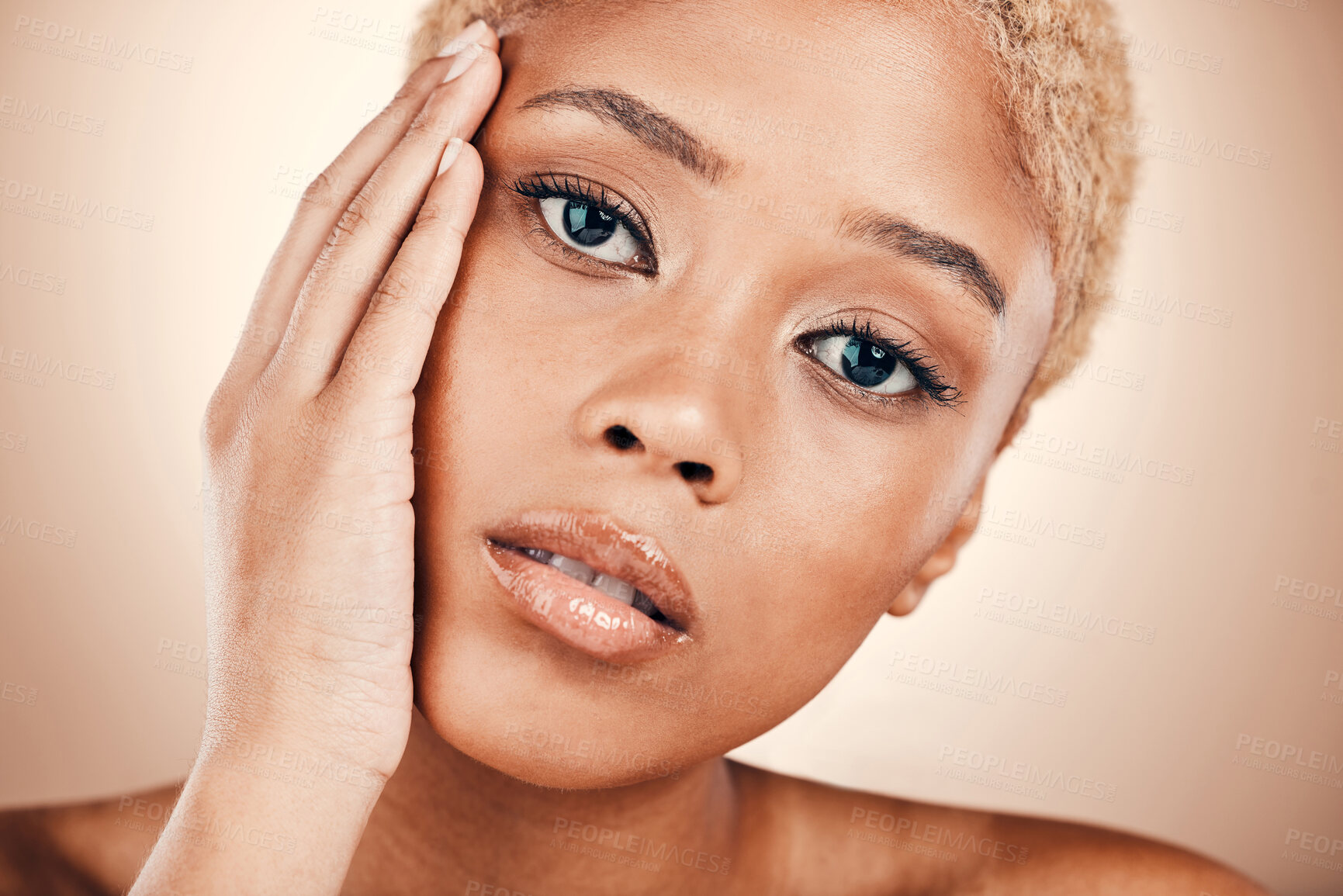 Buy stock photo Beauty, hand on face and portrait of a black woman on a brown background for cosmetics and skincare. Aesthetic model person with bronze makeup, facial glow and self care skin dermatology in studio