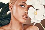 Flower, portrait and black woman with cosmetics, dermatology and treatment for wellness and confidence. Face, female and lady with plant, orchid and natural care for luxury, healthy and smooth skin