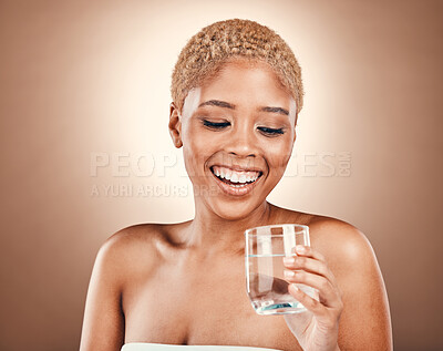 Buy stock photo Black woman, drinking water and glass for health on a brown background for skincare or diet. Aesthetic model person smile for clean and sustainable liquid for healthy lifestyle and wellness in studio