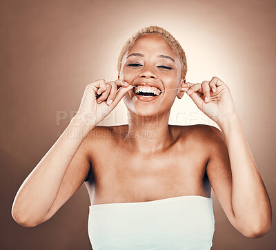 Teeth, dental floss and portrait of black woman on a brown background for healthy smile. Aesthetic model person laughing in studio for self care, cleaning mouth and hygiene for health and wellness