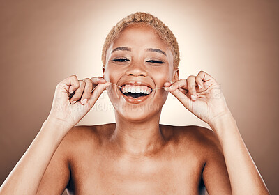 Black woman, flossing teeth and dental care portrait on a brown background for healthy smile. Laughing model person in studio for self care, cleaning mouth and funny hygiene for health and wellness