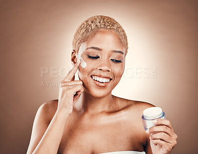 Buy stock photo Moisturizer product, cream and black woman smile with beauty skincare and face lotion in studio. Brown background, isolated and collagen dermatology of a model with makeup and skin glow for facial