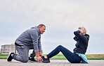 Fitness, health and sit ups with a senior couple training outdoor together for an active lifestyle of training. Workout, exercise or core with a mature man and woman outside on the promenade