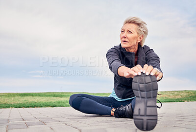 Woman, stretching exercise and fitness on blue sky mockup, park ground and training for cardio wellness. Senior female warm up legs outdoor for workout, sports running and thinking of healthy body