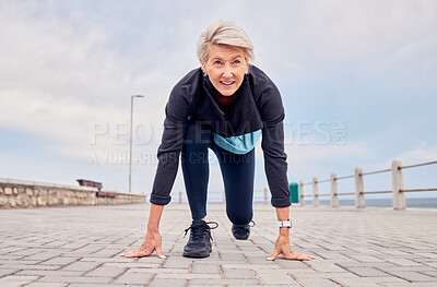 Buy stock photo Senior woman, starting position and running outdoor at beach promenade, runner exercise or sky mockup. Elderly lady ready to run, cardio and fitness training for mindset of sports, marathon or energy