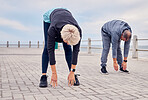 Stretching, pilates and senior couple by ocean for exercise, healthy body and wellness in retirement. Sports, fitness and elderly man and woman start warm up for running, cardio workout and training