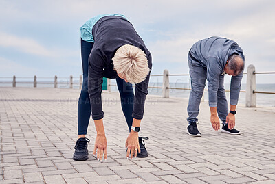 Buy stock photo Stretching, pilates and senior couple by ocean for exercise, healthy body and wellness in retirement. Sports, fitness and elderly man and woman start warm up for running, cardio workout and training