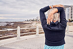 Back of woman, exercise and stretching at beach promenade for fitness, wellness and mockup. Lady, runner and person warm up arms at ocean for outdoor workout, sports action and healthy cardio running