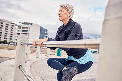 Buy stock photo Fitness, music and stretching with a senior woman getting redy for a cardio workout on the promenade. Exercise, warm up and running with a mature female athlete in preparation on an early morning jog