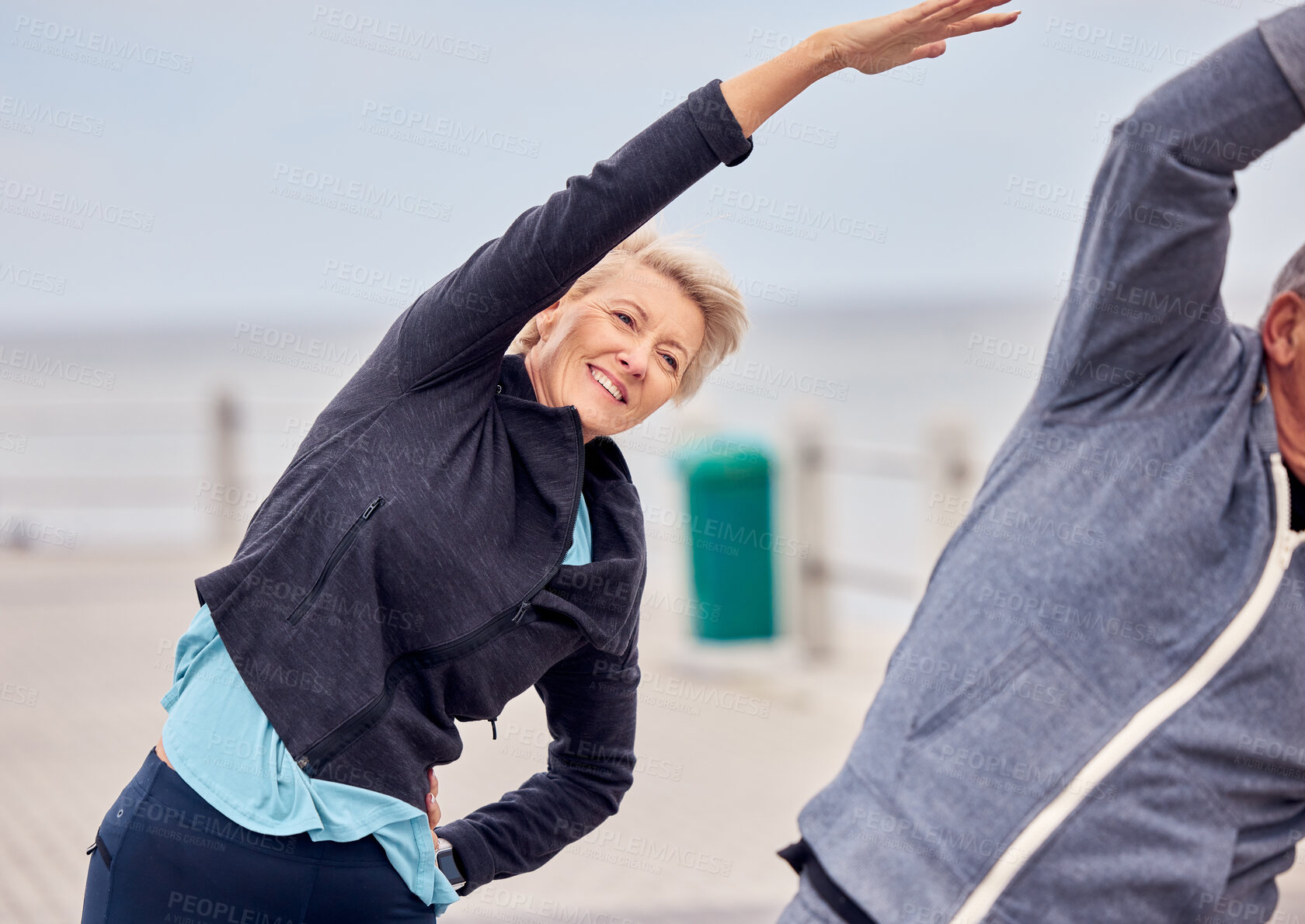 Buy stock photo Stretching, exercise and senior couple in city for pilates, healthy body and wellness in retirement. Sports, fitness and elderly man and woman ready for warm up, cardio workout and training by ocean