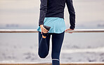 Fitness, outdoor and woman stretching her legs before running or training by the promenade. Sports, wellness and female athlete runner doing a warm up exercise before a cardio workout by the beach.