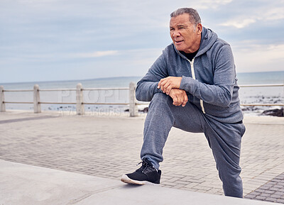 Buy stock photo Senior man, fitness and stretching at beach sidewalk for energy, wellness and healthy cardio workout. Elderly male, exercise and rest at seaside promenade for training, sports and breathing outdoor