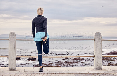Buy stock photo Back of woman, fitness and stretching at beach promenade to exercise, wellness and training. Lady, runner and person warm up legs at ocean for outdoor workout, sports action or healthy cardio running